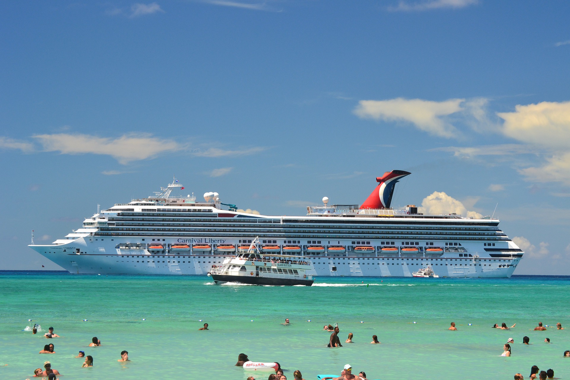 Carnival Liberty cruise ship off the coast of a beach (source: asram02, Pixabay)
