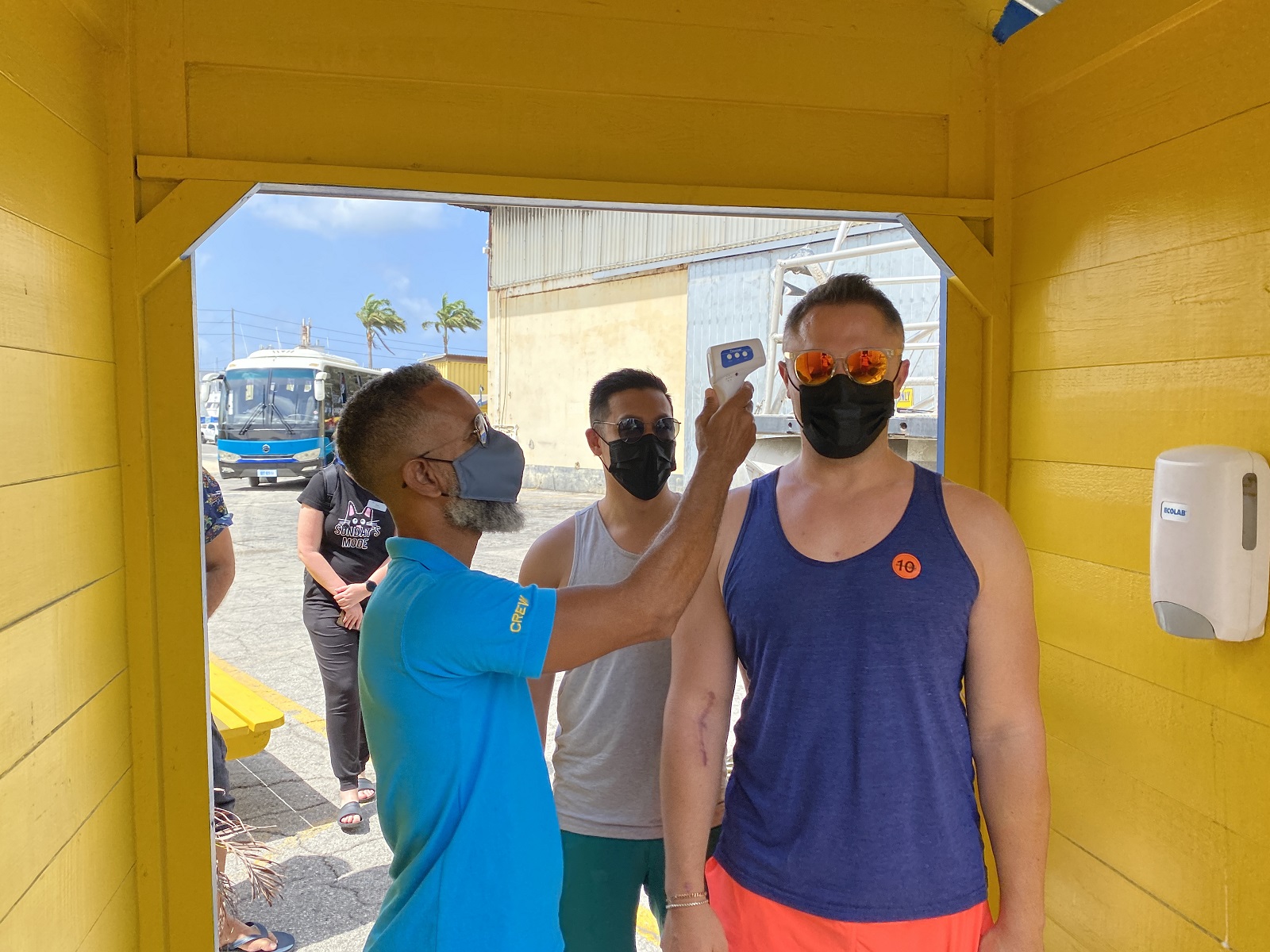 Passengers have their temperatures taken before a ship-sponsored shore excursion in Barbados