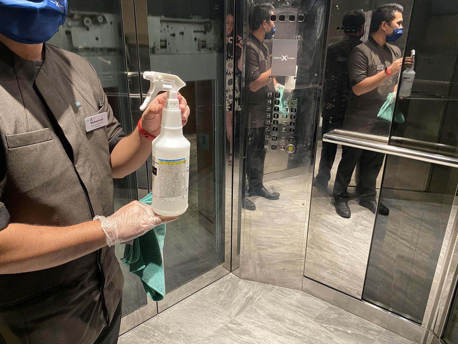 Crew member cleaning the elevator on Celebrity Millennium