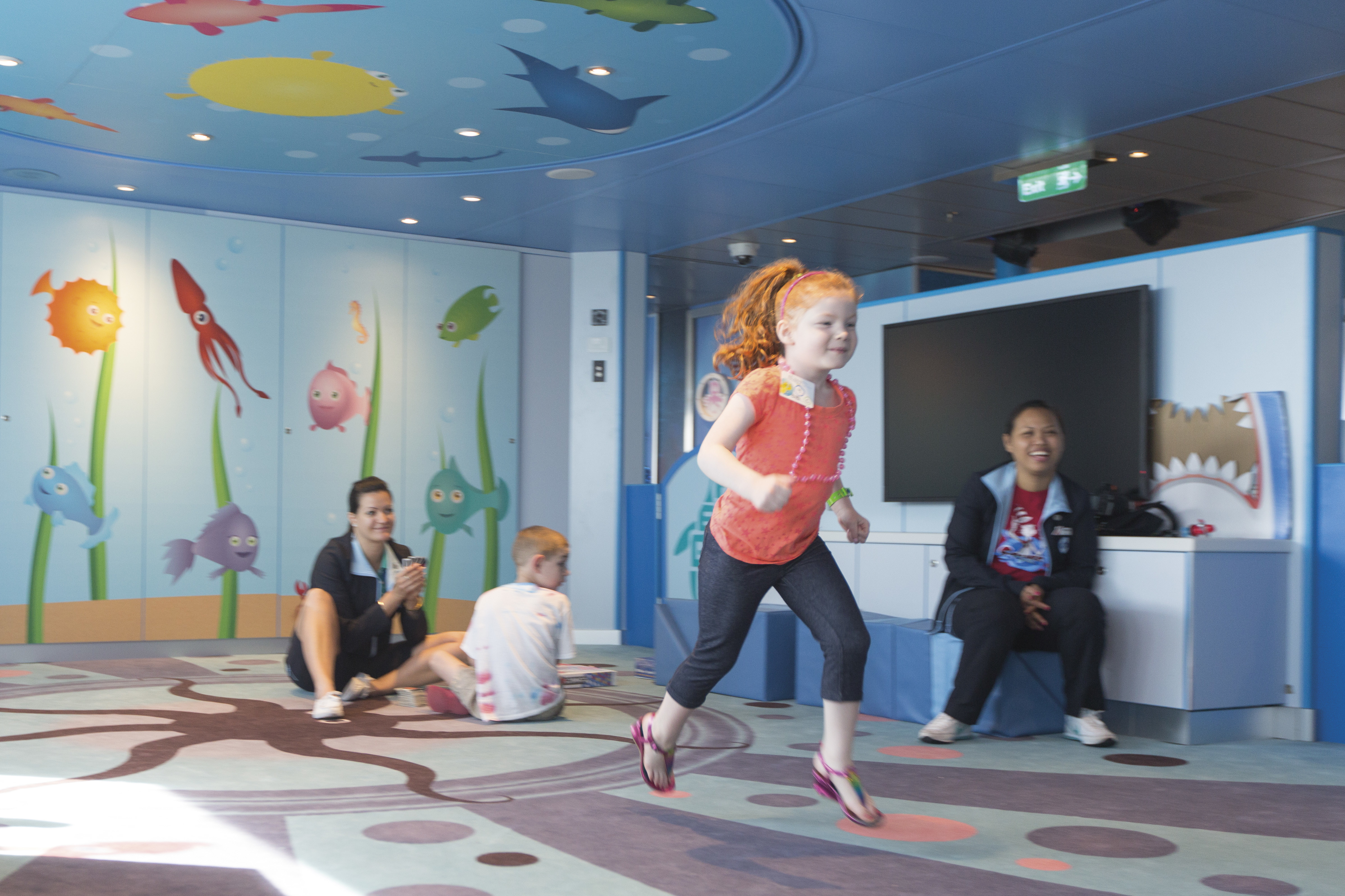 Little girl runs through play area- camp ocean penguins