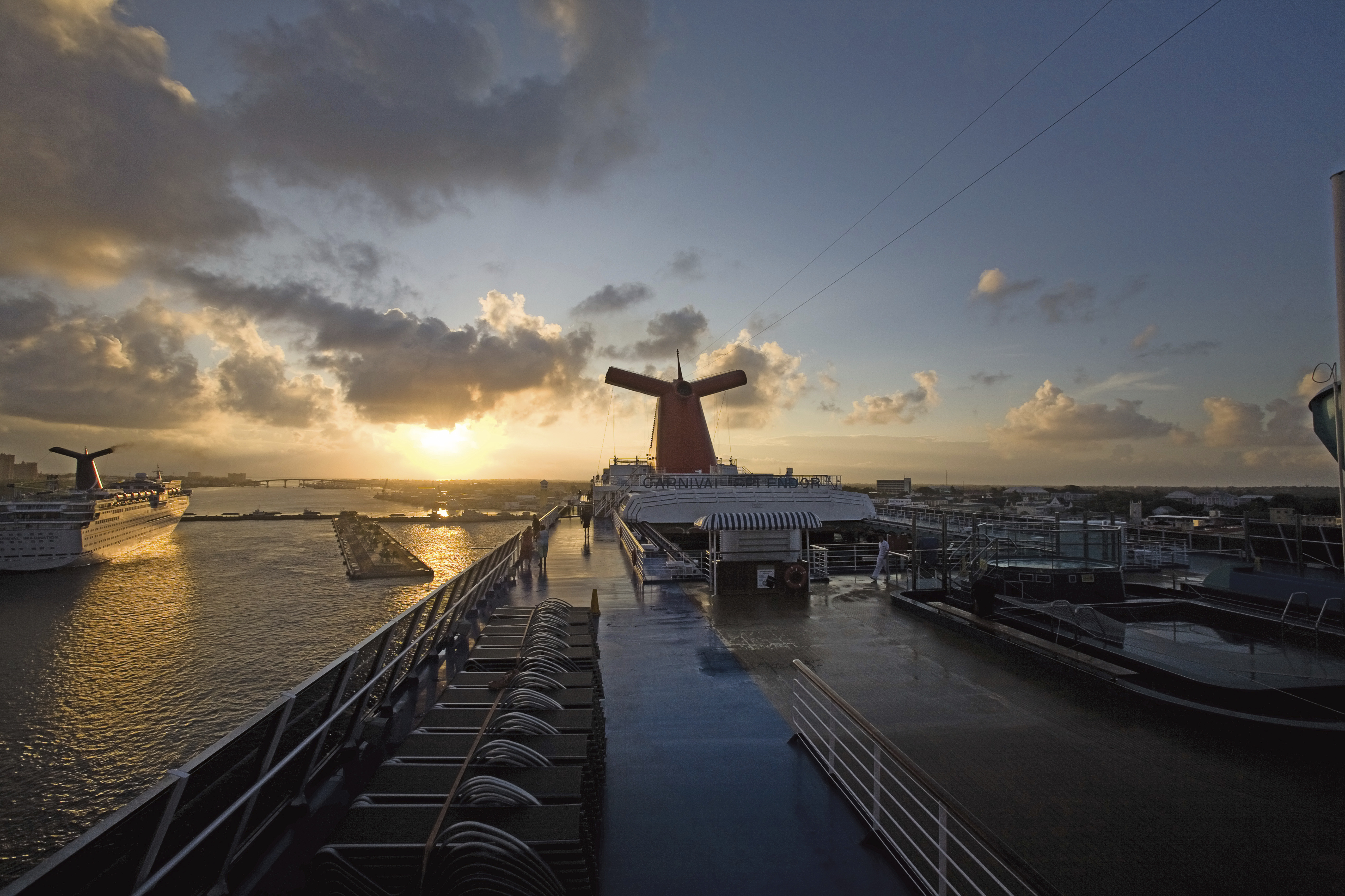 Carnival ship with sunset in background while at port