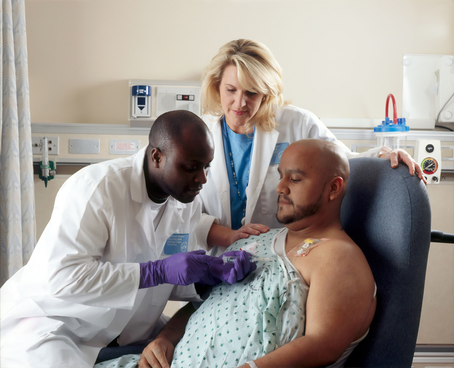 Two doctors working on a patient (source: National Cancer Institute, Unsplash)