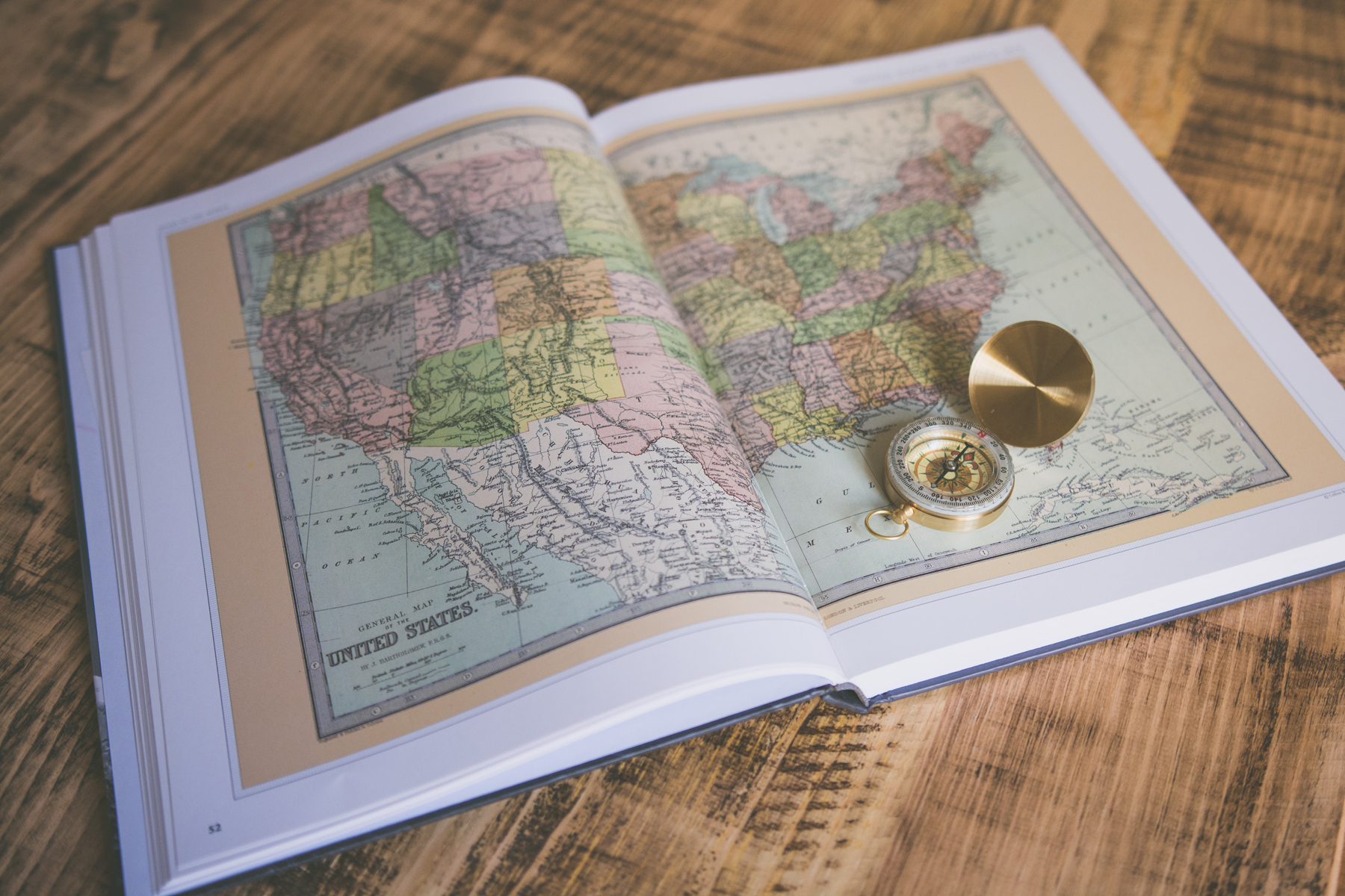 Map book with compass (source: Chris Lawton, Unsplash)