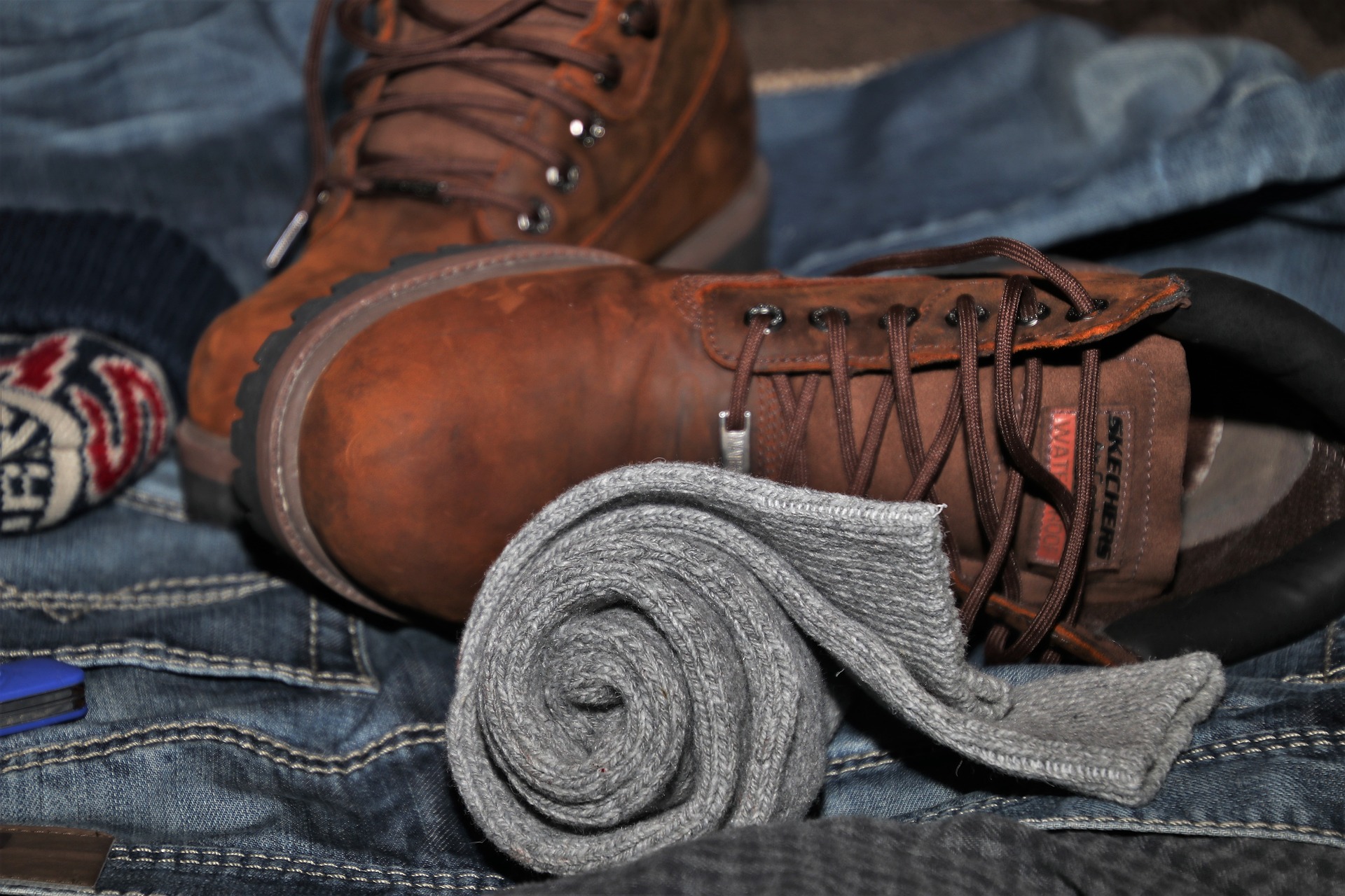 Suitcase close-up with rolled socks and hiking boots (source: pasja1000, Pixabay)