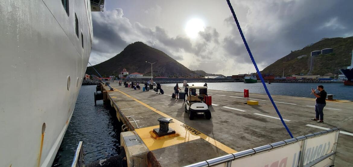 Crew members from the Carnival Pride are shown debarking the vessel to join repatriation flights returning them to their home countries.