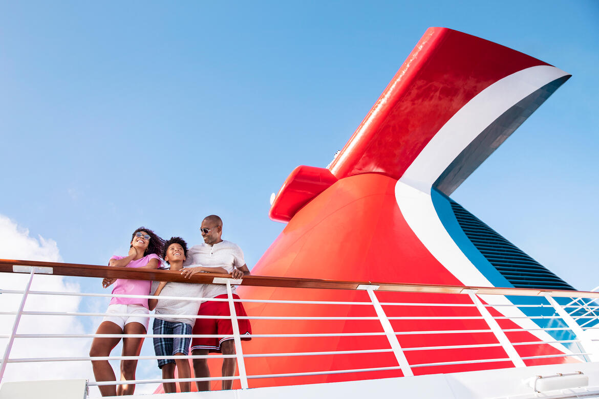 family at railing with funnel in back