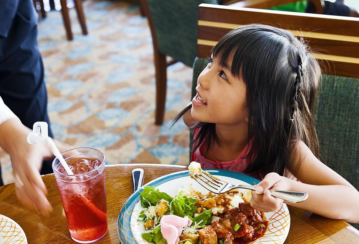 Girl eating at Windjammer buffet on Royal Caribbean
