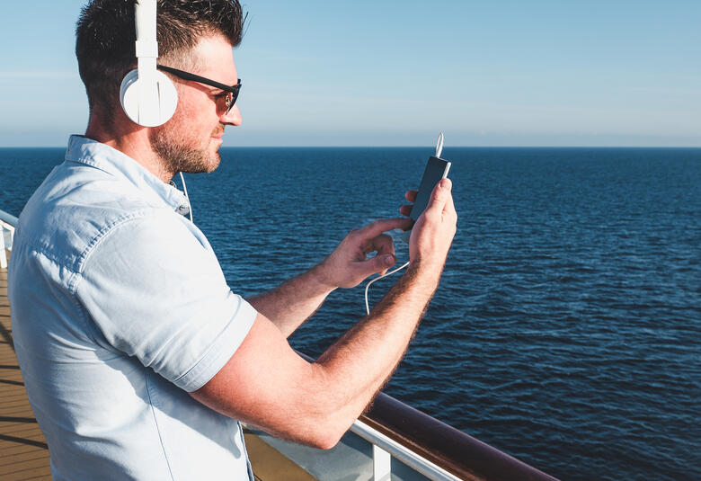 Man using phone on cruise ship