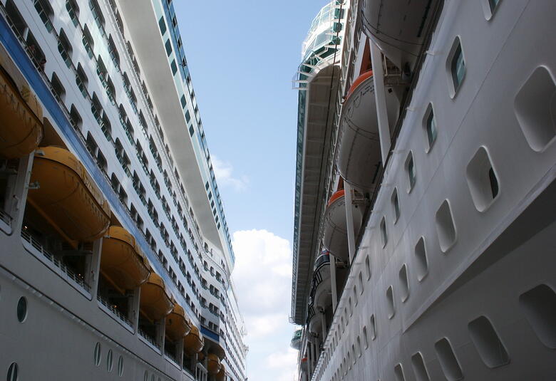 Two cruise ships docked next to each other