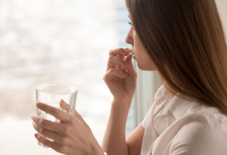 Woman taking a pill