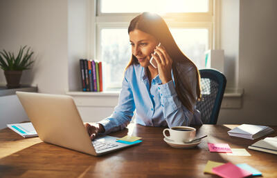 Woman on computer and phone