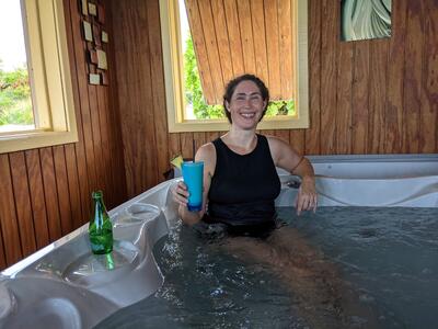 Woman in hot tub with tropical drink