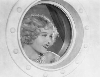 Woman looking through porthole