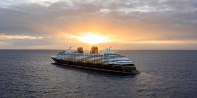 Disney cruise ship with sun setting