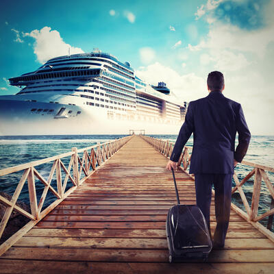 Man walking to cruise ship with luggage