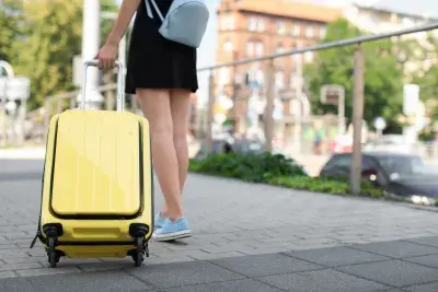 woman with yellow carry on suitcase
