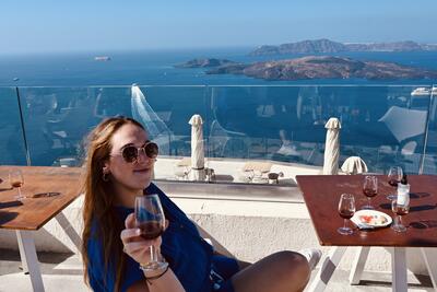 Allie Drinking Wine in Santorini
