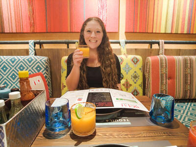 girl smiling while holding margarita