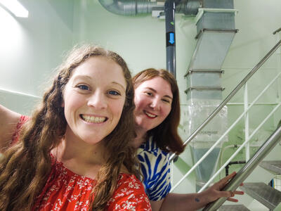 two girls smiling in a staircase