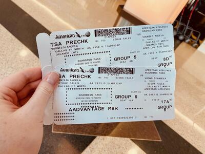 Airplane tickets in hand