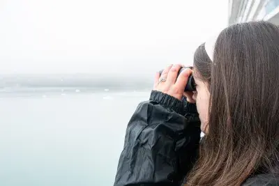 girl looking through binoculars