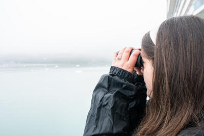 girl looking through binoculars