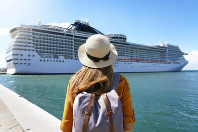 Woman Standing in front of a cruise ship
