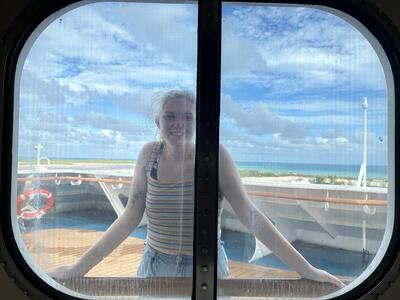 elizabeth leaning on window outside of JS