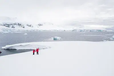 two people smiling in antarctica