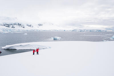 two people smiling in antarctica
