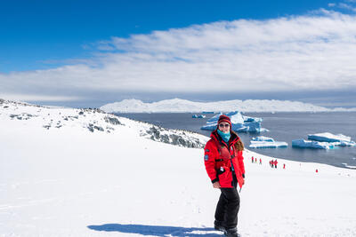 Girl standing on hillside in Antarctica