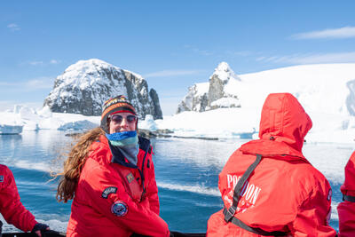 girl smiling on zodiac boat in Antarctica