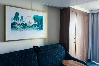 sofa, small table, wooden closet holding Murphy bed