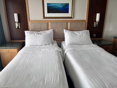 Separate beds inside suite cabin