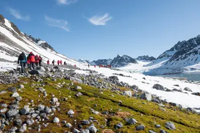 people hiking to a glacier in the Arctic