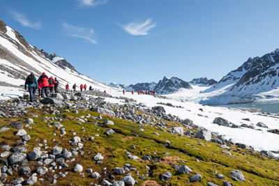 people hiking to a glacier in the Arctic