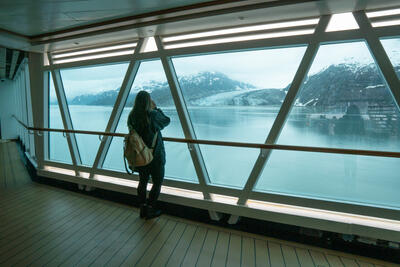 girl watching glaciers from cruise ship