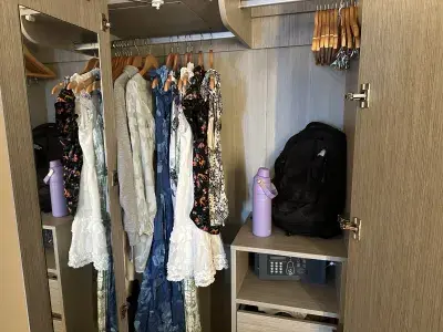 Clothing put away in a cruise ship closet