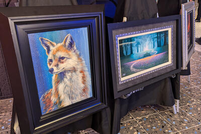 Two paintings on display on a cruise ship