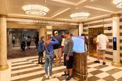 Cruise passengers waiting outside the dining room for dinner