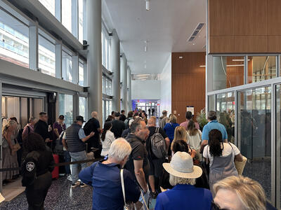 Long lines of people disembarking at a cruise ship terminal