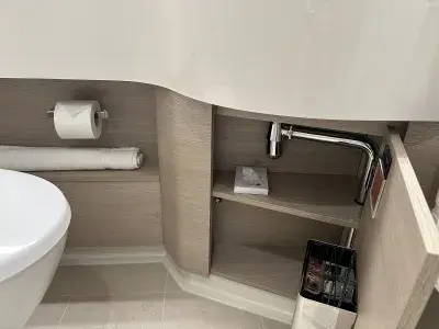 A strangely placed door under the sink in a cruise ship bathroom
