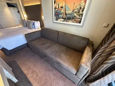 A sofa bed in a cruise ship cabin