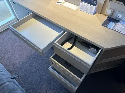 Drawer space at the desk and vanity on a cruise ship