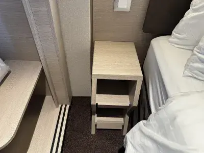 The minimal space between the closet and the bed in a cruise ship cabin