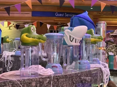 Souvenir cups -- including a crocodile, a blender and a shark -- on top of a bar