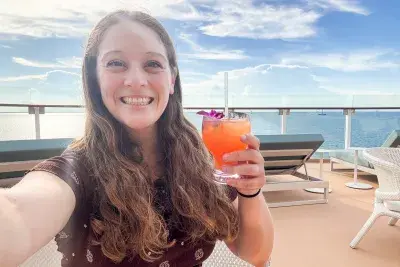Jenna taking a selfie with a cocktail on Star of the Seas