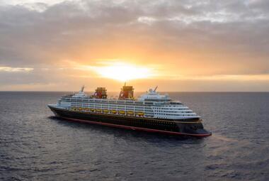 Disney cruise ship with sun setting