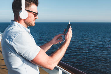 Man using phone on cruise ship
